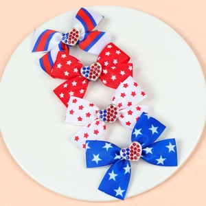 Detail of four American flag themed hair clips with rhinestone hearts on white ceramic
