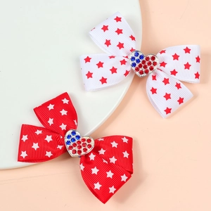 Pair of USA flag pattern hair bows with heart rhinestones and striped ribbon