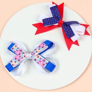 Detail view of layered grosgrain bow hair clips with stars and stripes patterns