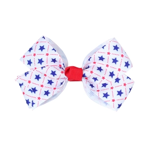 Detail of red white and blue bow hair clip with navy star print on grosgrain fabric