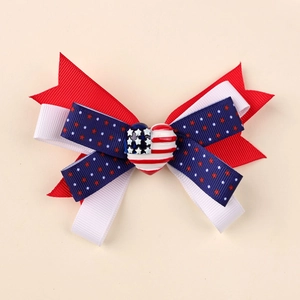Close-up of patriotic American flag bow clip with star pattern and heart center detail