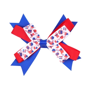 Close-up of Independence Day hair bow with red, white and blue ribbon and USA flag print