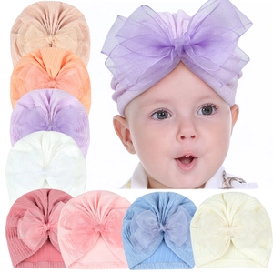 Detail of baby ribbed turban caps featuring large double-layered organza bows in 8 colors