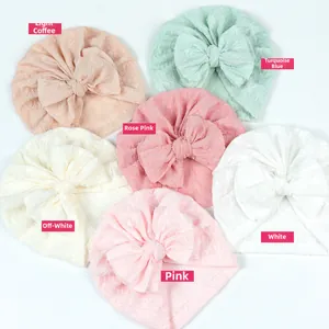 Flat lay of six colorful baby turbans with large bows in breathable waffle knit fabric