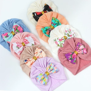 Baby turban hats with bow decorations in eight assorted solid colors for infants