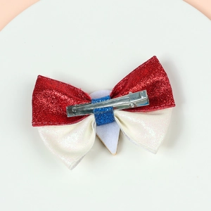Detailed back view of a glitter bow hair clip with a secure silver metal alligator grip