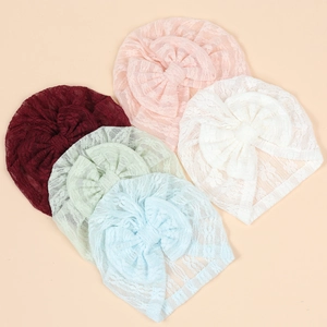 Detailed set of five soft lace baby beanies featuring large bows and floral patterns