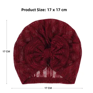Detailed view of dark red newborn lace hat with large bow and 17x17 cm size scale