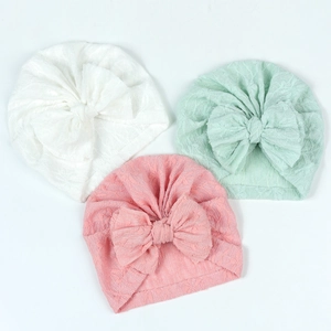 Three-pack of baby turban hats with large bows and textured knit fabric in three colors