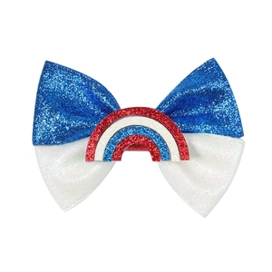 Detailed view of red white and blue glitter bow hair clip with a sequin rainbow design