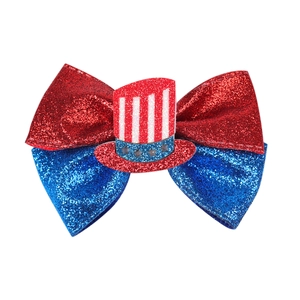 Close-up of Independence Day glitter bow hair clip with patriotic star and stripe hat