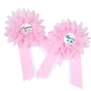 Pink Mommy To Be and Daddy To Be flower badges for baby shower and gender reveal parties
