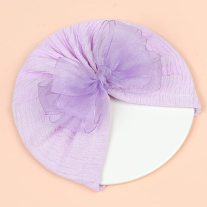 Detail of light purple baby hat with oversized organza bow and pleated knit texture