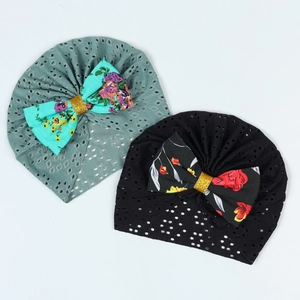 Detail of newborn turban hats with floral bows and breathable hollow mesh fabric