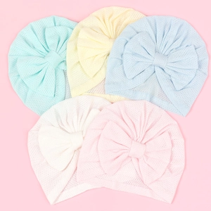 Detail view of five breathable infant turbans with large bows in various soft pastel colors