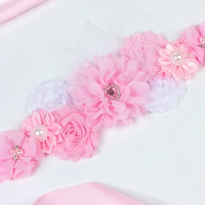 Detailed view of handmade pink floral maternity sash with chiffon roses and pearls