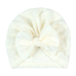 Detail of cream baby turban hat featuring breathable lace texture and large bow knot