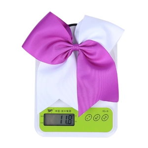 Detail showing the 11.8g weight of the purple and white grosgrain bow hair tie