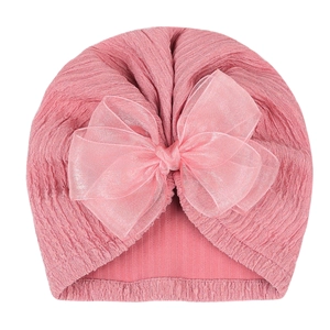 Detail of pink newborn turban hat featuring ribbed texture and large layered organza bow