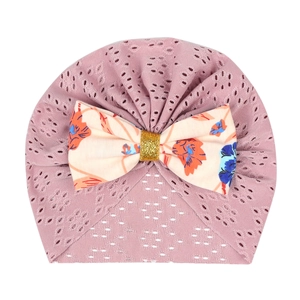 Detail of pink breathable hollow knit newborn hat with floral print ribbon bow accent
