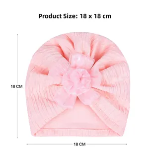 Pink jacquard baby turban hat with large flower detail and 18x18 cm size measurement