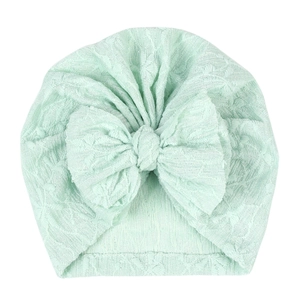 Detail of mint green baby turban hat with textured jacquard fabric and large bow