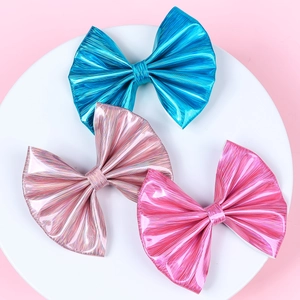 Three metallic faux leather hair bows in blue, champagne pink, and rose red colors