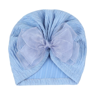Light blue knit baby turban with large organza bow on white background