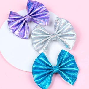 Three metallic faux leather bow hair clips in purple, holographic silver, and royal blue