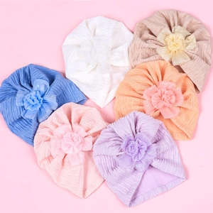 Infant turban hats with large fabric flowers in six assorted soft colors for baby girls