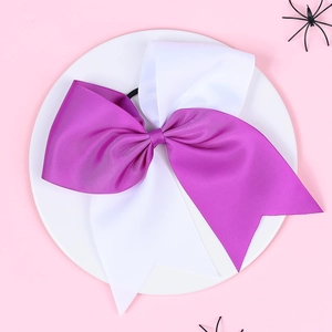 Macro shot of large purple and white layered grosgrain ribbon bow with elastic band