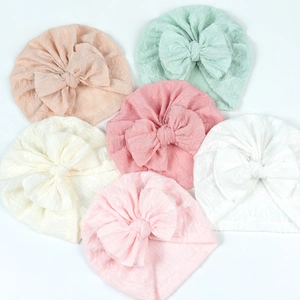 Breathable baby turban hat with large bow in six soft pastel colors and jacquard texture