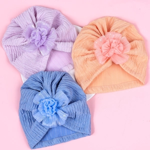 Set of three ribbed baby turbans in lavender, coral, and blue with 3D fabric flowers