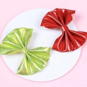 Detail of glossy metallic hair bows with pleated texture in red and lime green