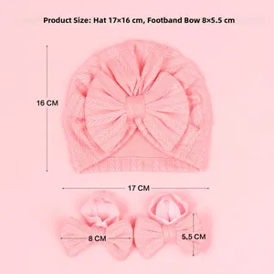 Pink newborn ribbed hat and bow anklet set featuring soft knitted earflap design