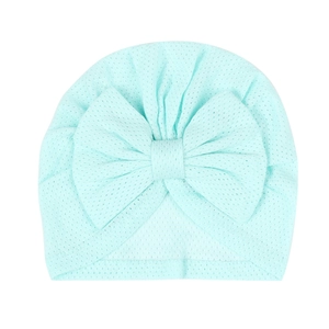 Detail showing the breathable mesh texture and large bow on a mint blue baby beanie