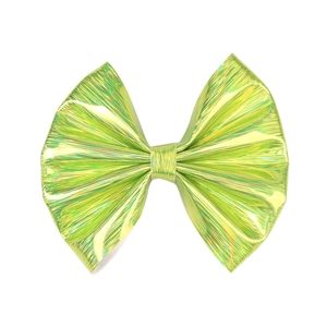 Close-up of holographic green leather bow hair clip with textured metallic finish