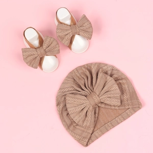 Detail of baby knit turban hat and matching bow sandals set with V-pattern texture