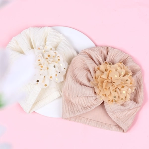 Infant ribbed turban hats with golden polka dot mesh flowers in white and pink