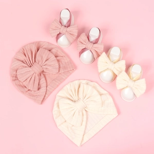 Newborn baby turban hat and bow foot set in soft knitted pink and cream fabric