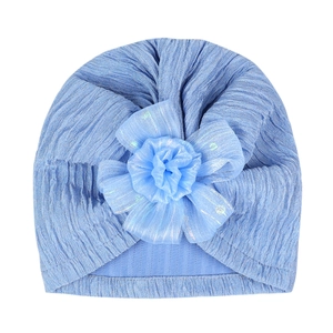 Detail of baby turban hat featuring a large light blue jacquard mesh flower