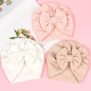 Three-pack soft waffle knit baby turbans with large bows in pink, white and beige
