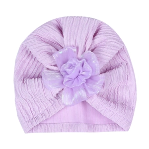 Soft purple pleated baby turban hat with delicate pearlized fabric flower decoration