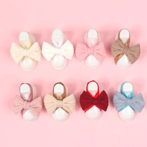 Eight-piece set of newborn baby bow headbands and foot straps in soft pastel colors