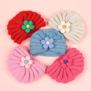 Five assorted colors of knit baby beanies with cute floral accents and ribbed texture
