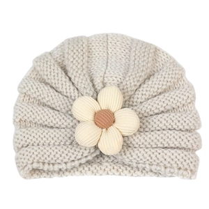 Detailed knit texture of beige baby beanie with 3D five-petal floral applique