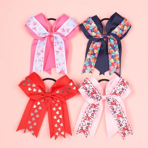 Set of four girls' ribbon bow hair ties with assorted heart patterns and Love motifs