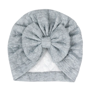 Detailed close-up of grey baby turban hat featuring a large bow and soft knit fabric texture