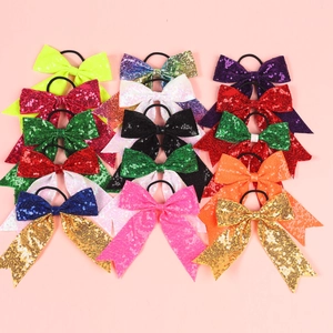 Flat lay view of colorful sequin bow hair ties with elastic bands in multiple bright colors