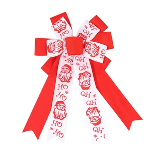 Christmas hair bow with Santa Claus pattern and festive ribbons for young girls